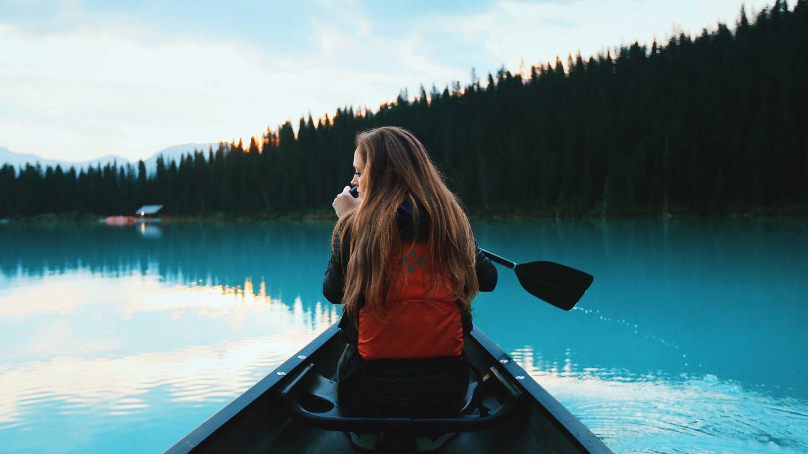The input photo: canoe on a still mountain lake